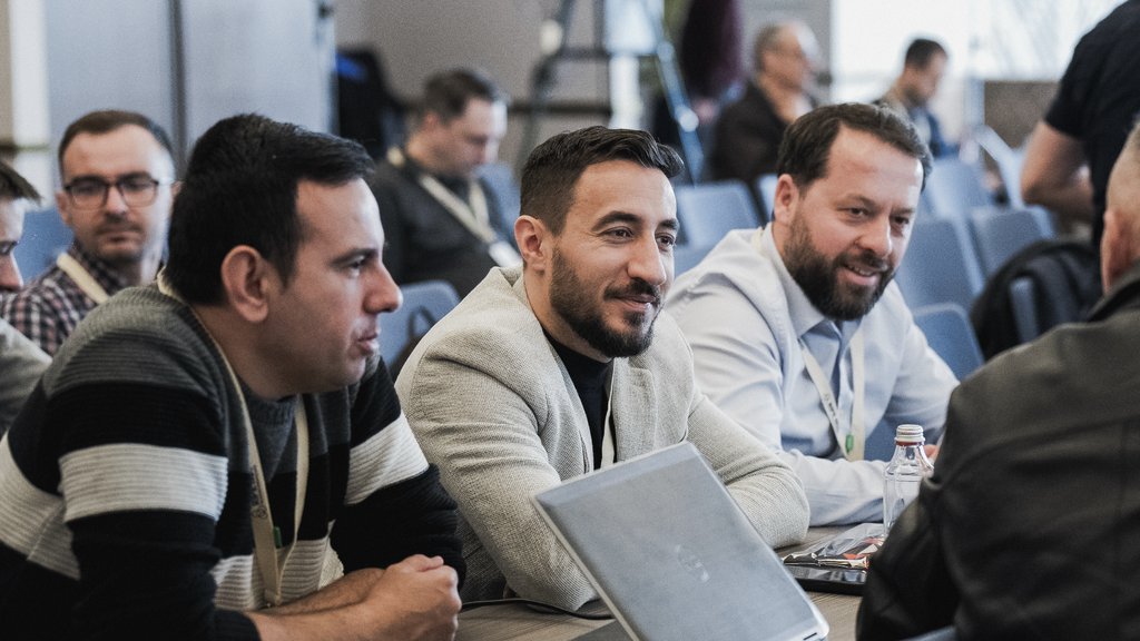 a photo of three man chatting